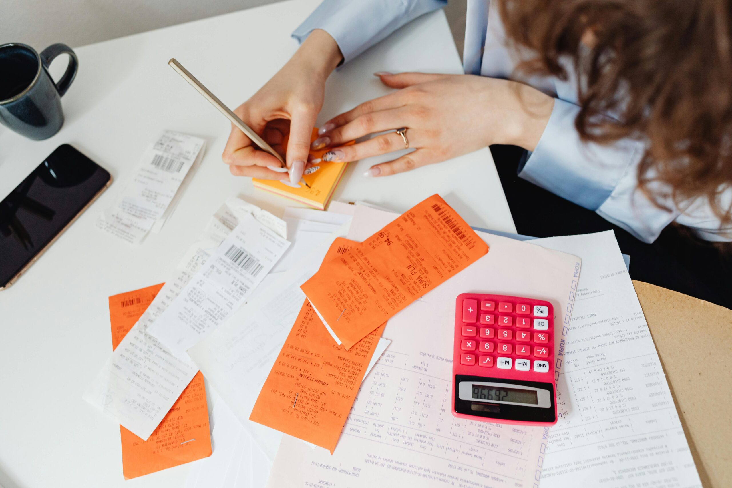 Small business bookkeeping and accounting workspace with receipts, calculator, and financial documents