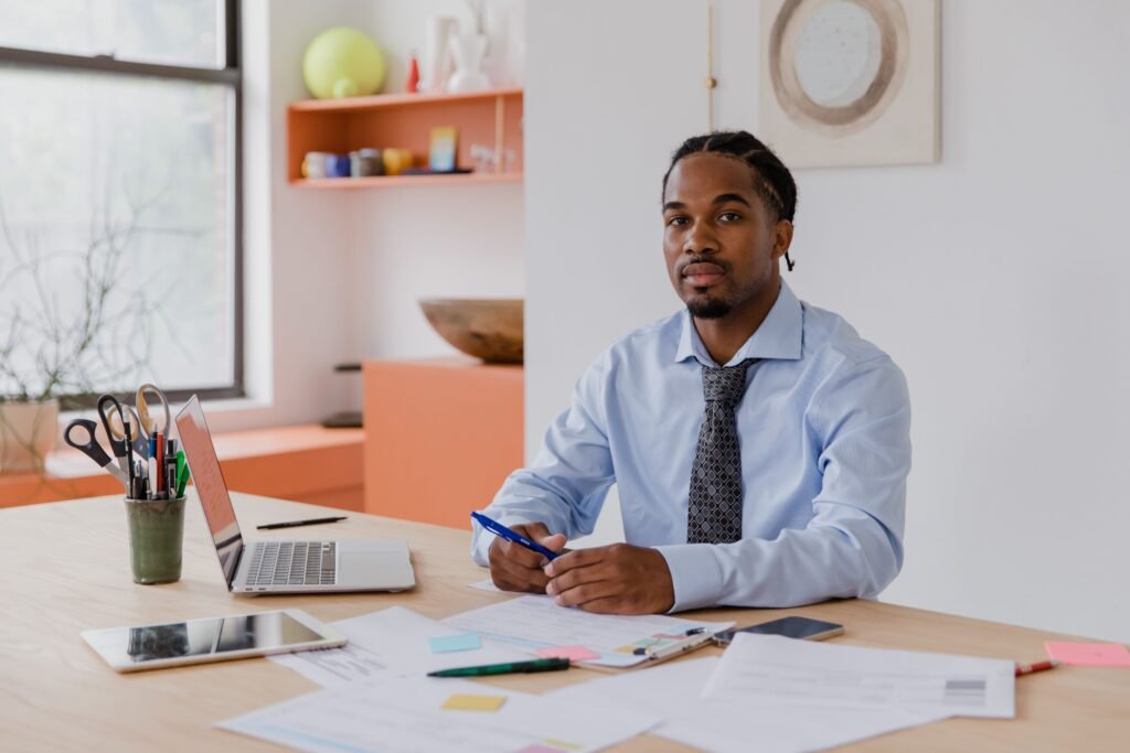 Behind on Bookkeeping? How to Catch Up on Your Books Step by Step Small business owner reviewing financial records while catching up on bookkeeping